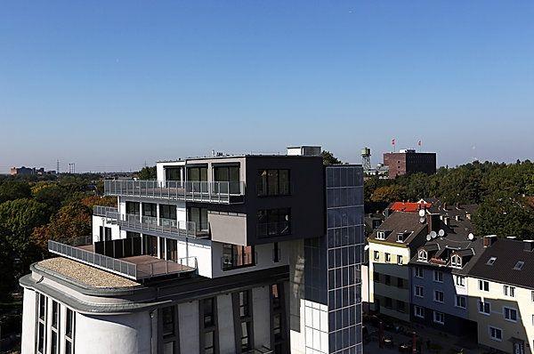 Modern mehrstöckiges Gebäude mit dunklen und weißen Fassaden und weitem Himmel