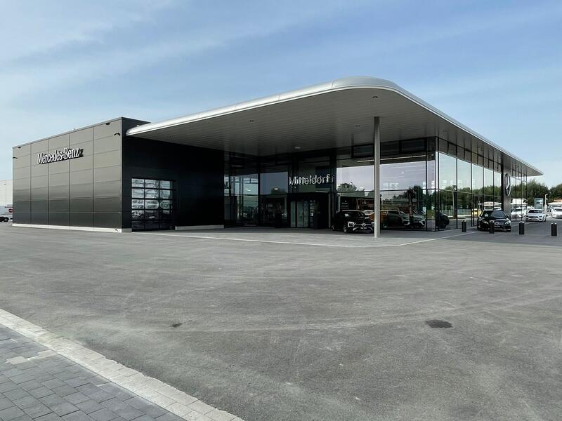 Modernes Mercedes Benz Autohaus mit großer Glasfassade und dunkler Außenverkleidung